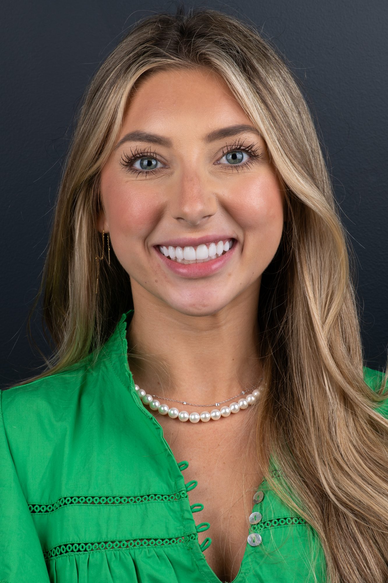 A Smile On Nashville patient smiling brightly, wearing a pearl necklace