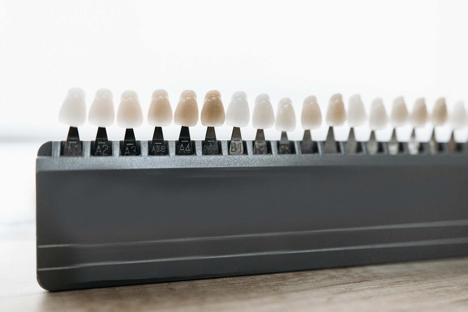 Dental shade guide with rows of sample teeth in different whites
